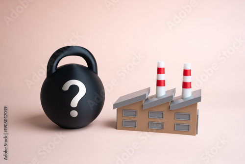 Tablou pe pânză An industrial plant and a black weight with a question mark
