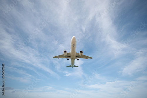A huge passenger plane is landing in airport of Phuket, Thailand, a bottom view 