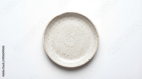 Empty ceramic round plate isolated on white background. View from above.