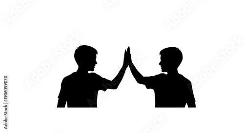 Two people giving each other a high five in silhouette.
