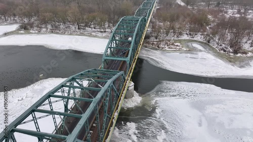 Aerial Vistula River ice winter Fordon bridge Poland 1 4K. Winter season cold arctic temperatures, ice flows, dangerous ice jams damage waterway. Longest river Poland. From Baltic Sea. 