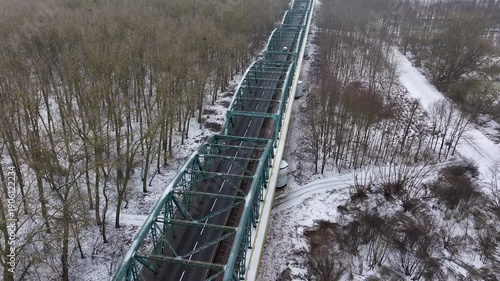 Aerial Vistula River ice winter Fordon bridge Poland 1 4K. Winter season cold arctic temperatures, ice flows, dangerous ice jams damage waterway. Longest river Poland. From Baltic Sea.