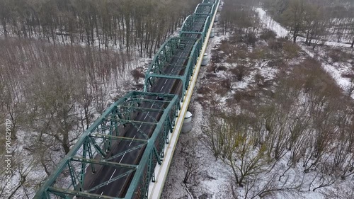 Aerial Vistula River ice winter Fordon bridge Poland 1 4K. Winter season cold arctic temperatures, ice flows, dangerous ice jams damage waterway. Longest river Poland. From Baltic Sea. 