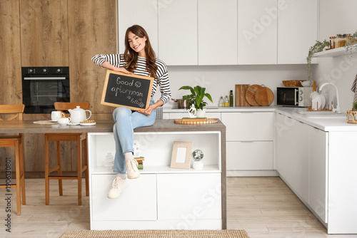 Young woman holding chalkbo...