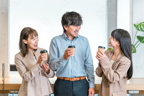Businessman and businesswoman chatting over coffee in the office