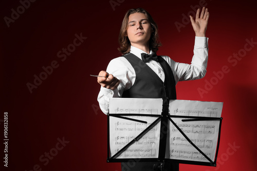 Male conductor with note sh...