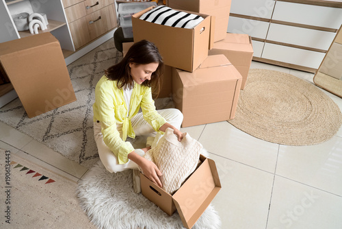 Young woman packing sweater...