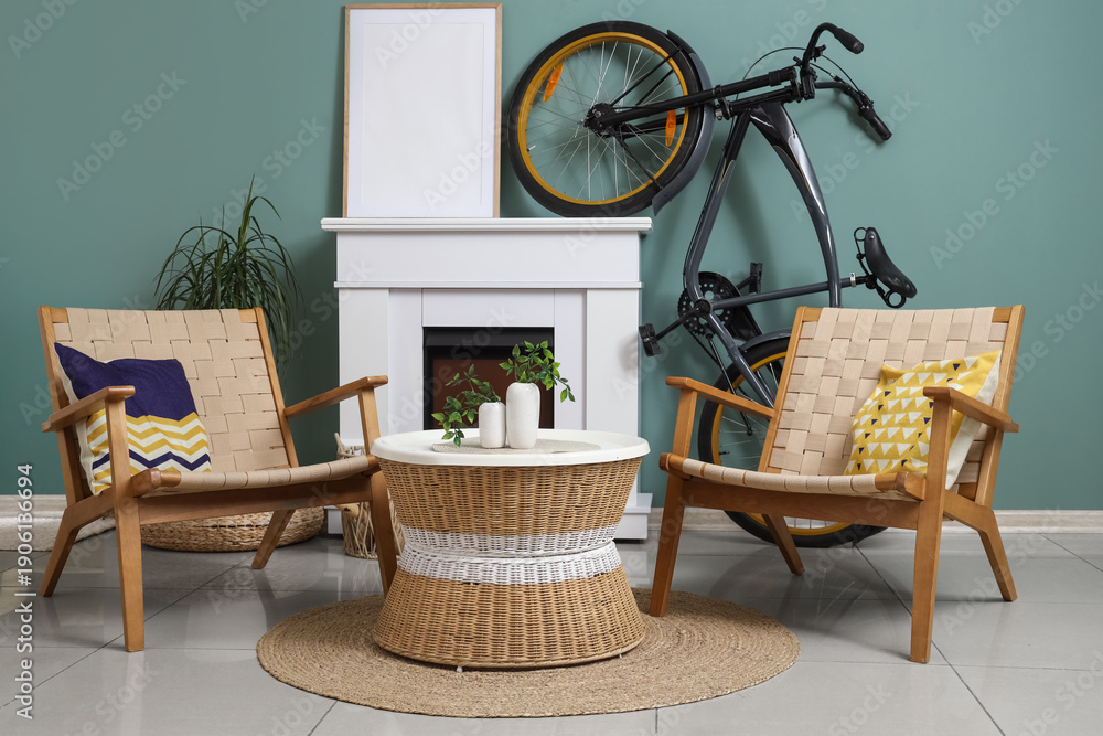 Naklejka premium Interior of living room with bicycle, fireplace and armchairs