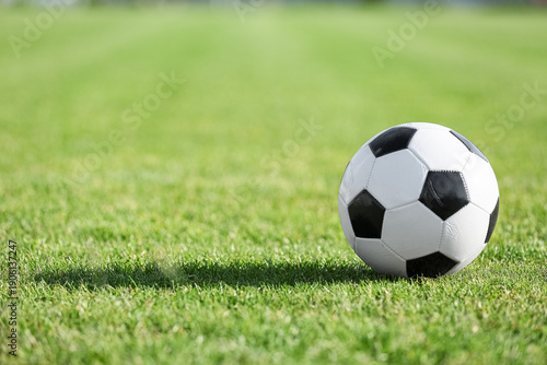 Soccer ball on green grass,...