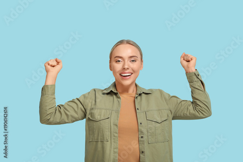 Happy young woman celebrati...