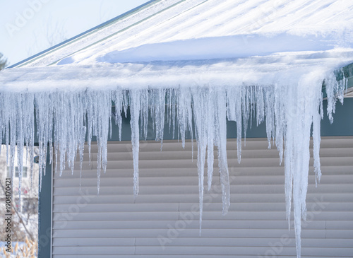 winter house with icicle and snow on the roof
