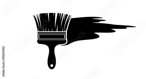 Paintbrush with black paint strokes on a surface viewed from a close-up perspective