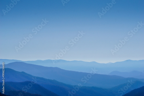 The mountains are covered in blue and the sky is clear