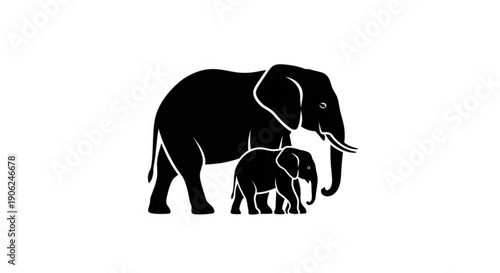 Mother elephant and calf walking together in silhouette