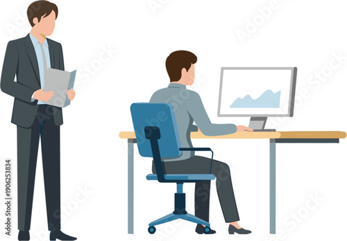 Professional office scene with male colleague standing holding document while coworker sits at desk analyzing data on computer monitor