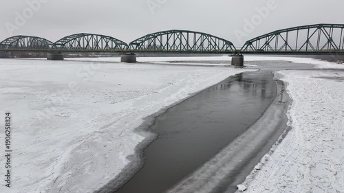 Aerial Vistula River ice winter Fordon bridge  Poland 1 4K. Winter season cold arctic temperatures, ice flows, dangerous ice jams damage waterway. Longest river Poland. Navigable from Baltic Sea.