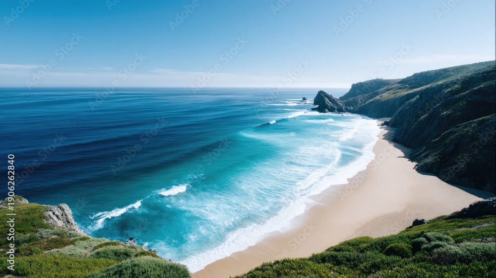 Fototapeta premium Scenic Coastal View of Serene Beach and Turquoise Ocean Waves under Clear Blue Sky with Rolling Cliffs and Lush Greenery in the Background