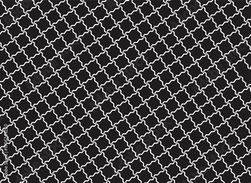 Chain link fence silhouette with dark background and metal mesh texture