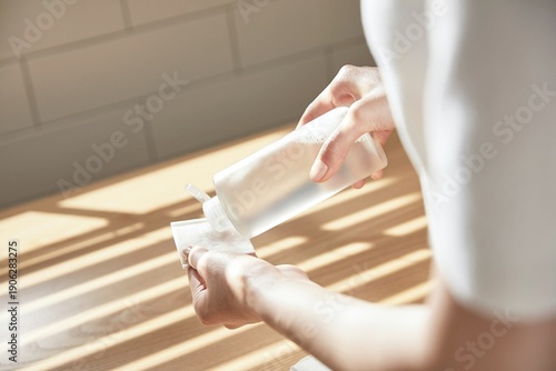 Wallpaper Mural A hand holding a product in a space where natural light comes in Torontodigital.ca