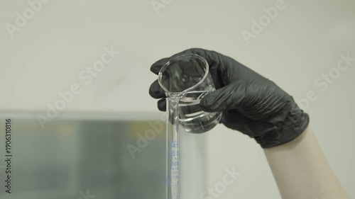 Beaker pouring liquid in tube in laboratory 4k