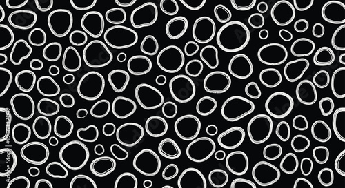 A black and white abstract pattern of irregular white shapes on a black background
