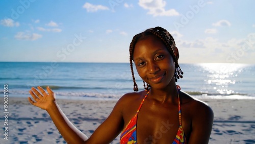 Smiling african female on sunny beach with ocean view.