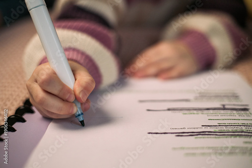 Obraz na plátně Caucasian child writing on paper with marker, hand holding pen while crossing ou