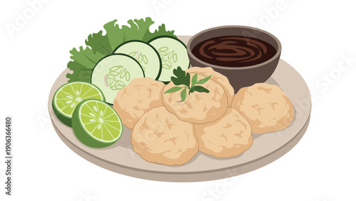 Traditional indonesian pempek dish from palembang served on a plate with cucumber slices lime and spicy vinegar dipping sauce.