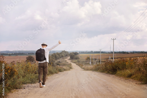 Photography A man walks along a country road