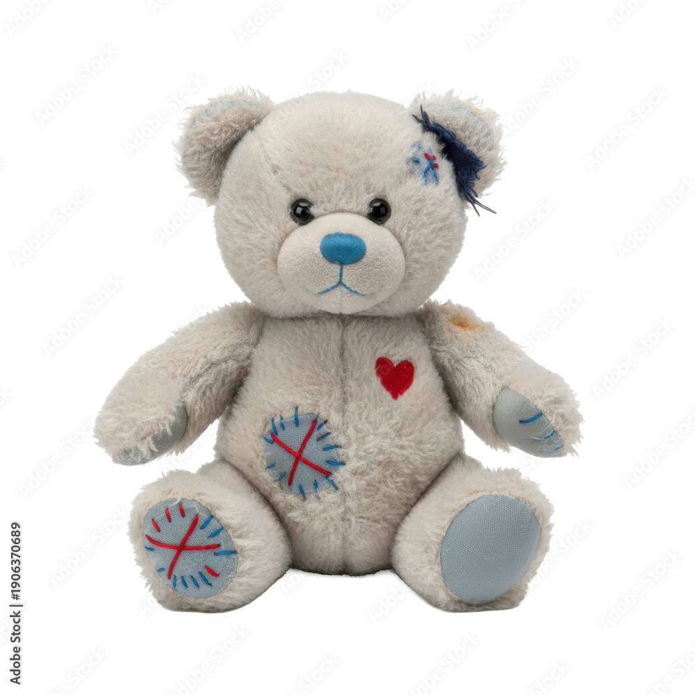 Obraz premium Worn teddy bear with patches and a heart