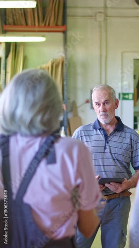 Senior manager listening to worker complaining in a workshop