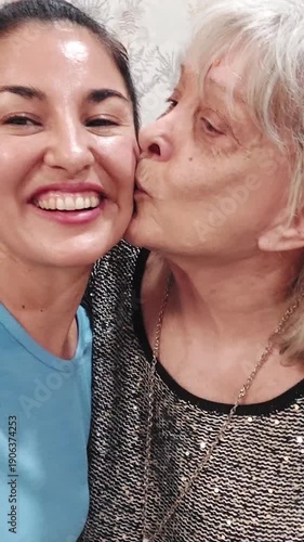 Affectionate granddaughter taking a selfie with grandmother