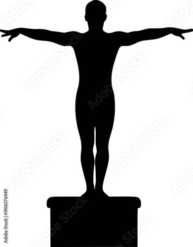 Silhouette of a person with arms outstretched standing on a pedestal