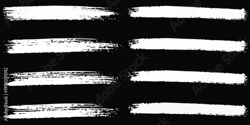 Abstract white brush strokes on a black background creating bold lines