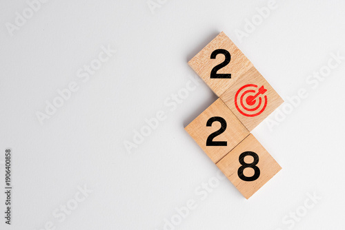 Happy new year 2028, modern minimal banner. Business goal plan, building success concept. 2028 year numbers with target icon on eco wooden hexagon blocks isolated on blue background with copy space.