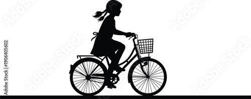 Silhouette of a girl riding a bicycle with a basket on the front