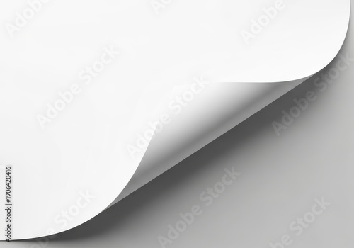 Blank white paper sheet displays a corner turned over showing shadow and background surface