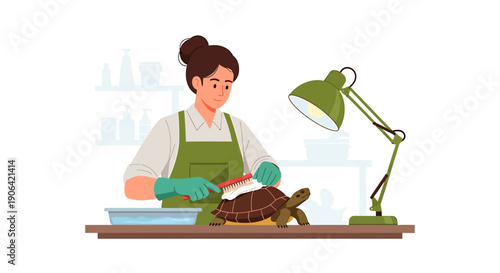 Woman cleaning a turtle with a brush under a lamp.
