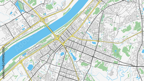 Detailed top down view of a city street map showing roads buildings parks and a large blue river for navigation and urban planning applications.