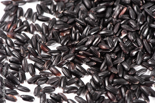 closeup of black rice on white background