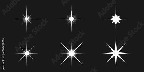 A collection of bright white starbursts and sparkling light effects on black