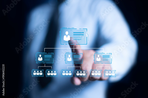 Businessman point a glowing digital organizational chart, leadership and team structure. HR Manager works on HR company structure tree diagram, resource leveling, and career path concepts.