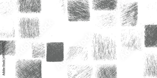 Scattered grey textured brush stroke rectangles and squares on white background