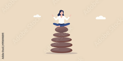 Woman meditating in a lotus position atop a stacked stone tower