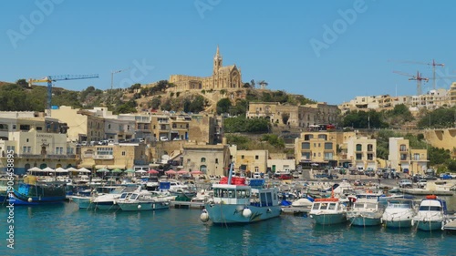 Wallpaper Mural Fishing boats moored in Mgarr harbor with Lourdes Chapel on the hill, Gozo, Malta. Torontodigital.ca