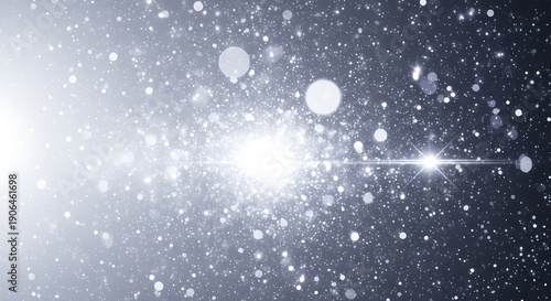 Sparkling white particles on dark background with bright light