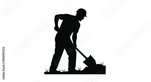 Silhouette of a worker digging with a shovel in a field
