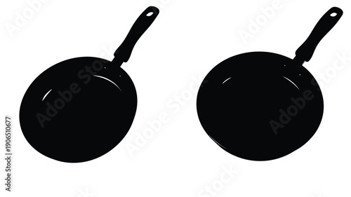 Two black frying pans displayed against a white background silhouette