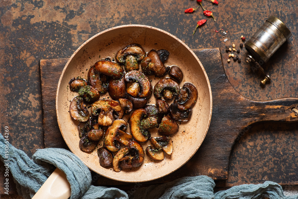 Fototapeta premium Sauteed Mushrooms With Fresh Herbs In A Rustic Pan Setting
