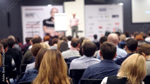 Wallpaper Mural People gathered in conference meeting room listening to speaker during business presentation. collaboration and learning. group Audience sit chairs. professional speech. man speak seminar stage. talk Torontodigital.ca